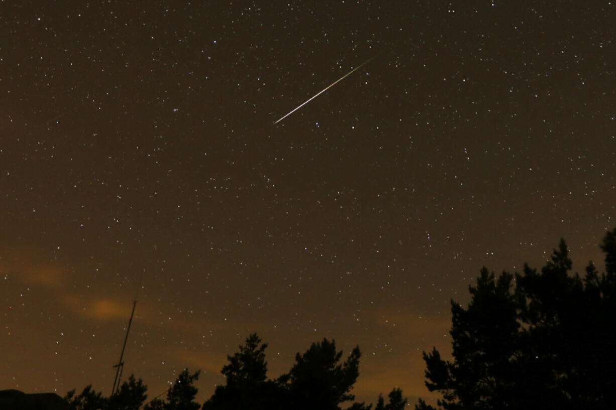 In this long exposure photo, a streak appears in the sky during the annual Perseid meteor shower at the Guadarrama mountains, near Madrid, in the early hours of Aug. 12, 2016. The best viewing for the annual shower visible around the world will be from Saturday night into early Sunday morning, when viewers might spot a meteor per minute.