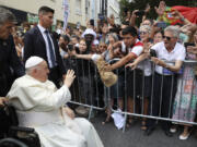 Pope Francis waves to the crowd as he arrives for a meeting with the Portugal's Prime Minister Antonio Costa in Lisbon, Wednesday, Aug. 2, 2023. Pope Francis arrived Wednesday in Lisbon to attend the international World Youth Day on Sunday that is expected to bring hundreds of thousands of young Catholic faithful to Portugal. (Miguel A.