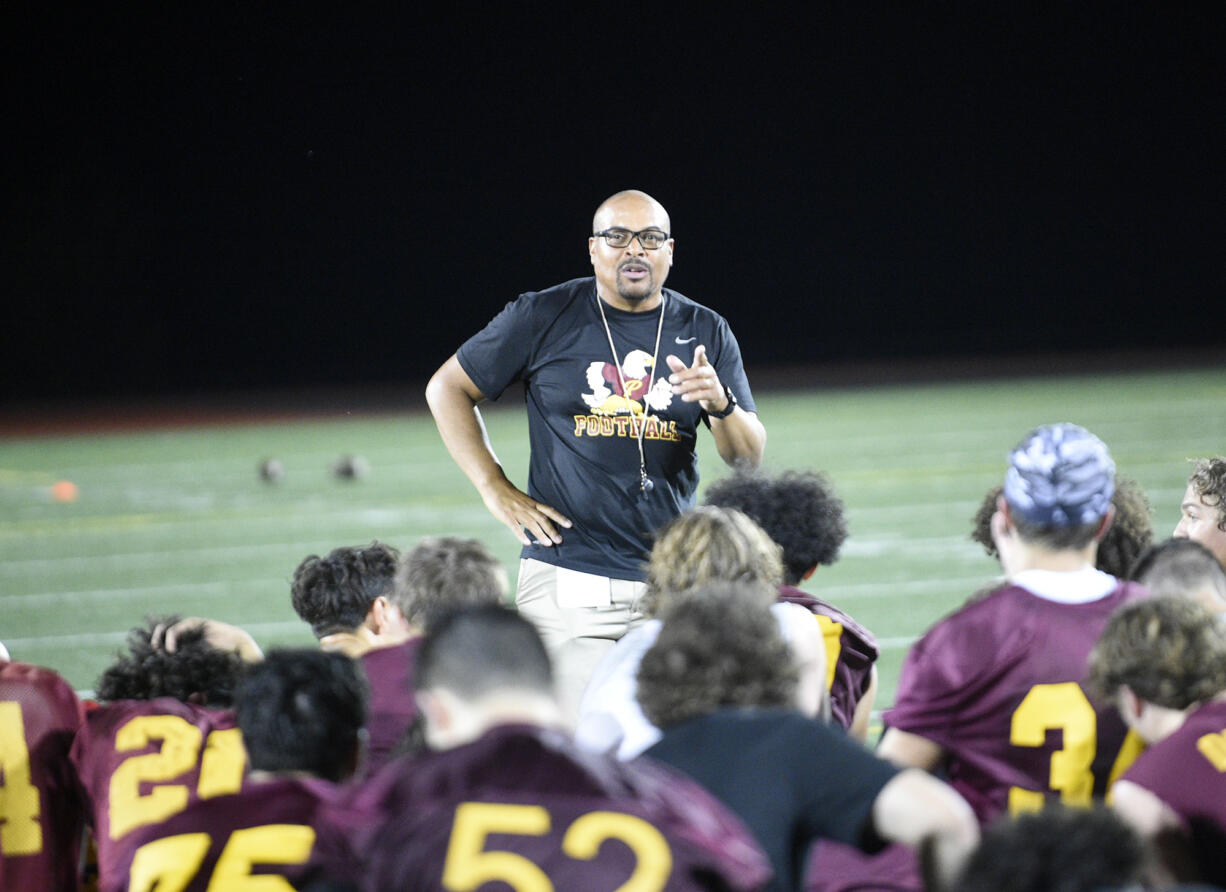 Prairie head coach Will Ephraim talks with his players at the Falcons' midnight practice at Prairie High School on Wednesday, Aug. 16, 2023.