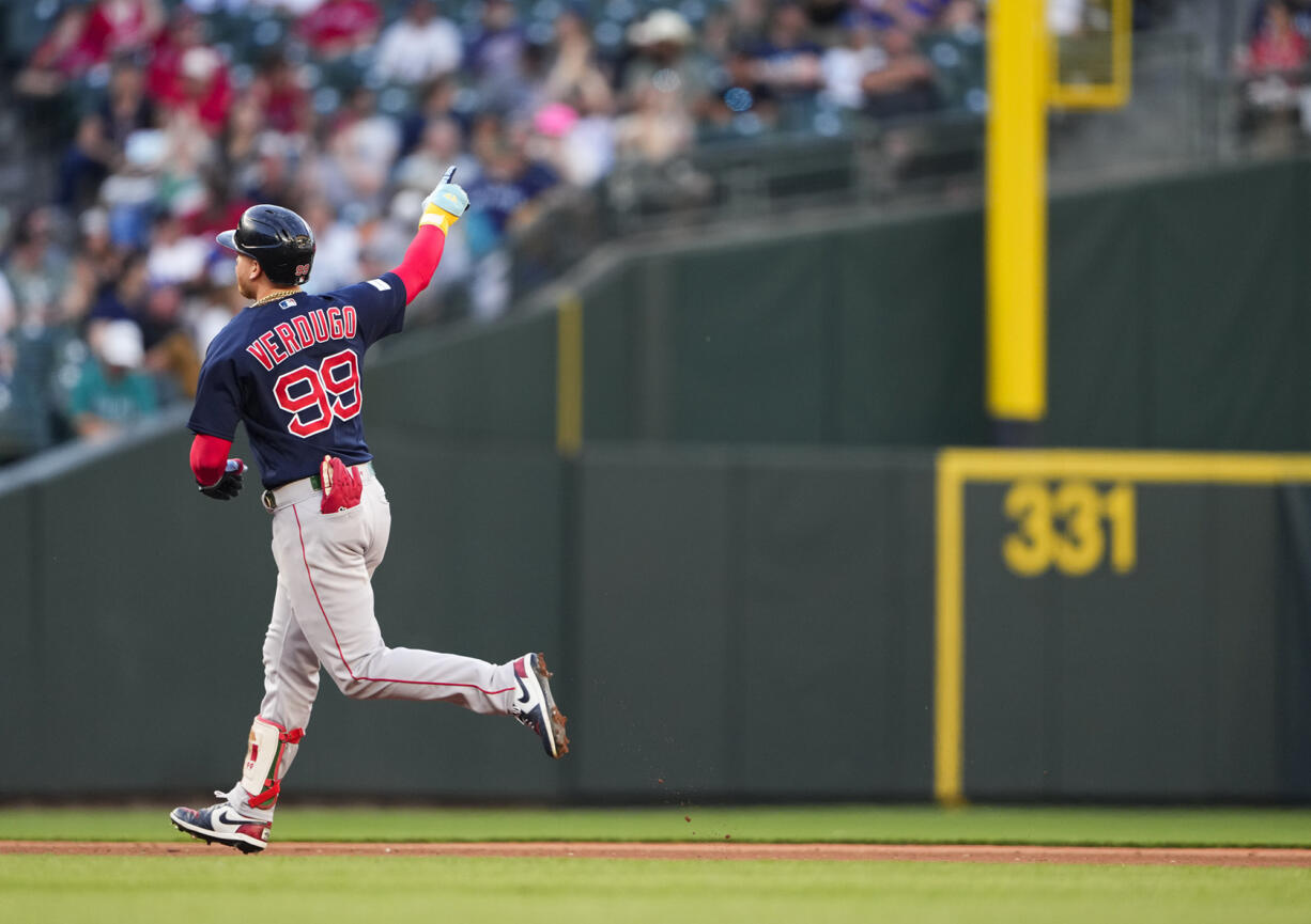 Boston Red Sox's Alex Verdugo points to the bullpen as he rounds the bases after hitting a two-run home run against the Seattle Mariners during the fifth inning of a baseball game, Tuesday, Aug. 1, 2023, in Seattle.