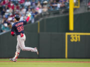 Boston Red Sox's Alex Verdugo points to the bullpen as he rounds the bases after hitting a two-run home run against the Seattle Mariners during the fifth inning of a baseball game, Tuesday, Aug. 1, 2023, in Seattle.