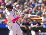 Seattle Mariners' Julio Rodriguez breaks his bat on an RBI single against the Boston Red Sox to score Tom Murphy during the seventh inning of a baseball game, Wednesday, Aug. 2, 2023, in Seattle.