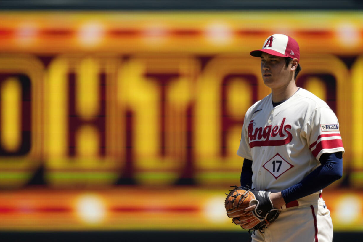 Los Angeles Angels starting pitcher Shohei Ohtani gets set to pitch during the first inning in the first baseball game of a doubleheader against the Cincinnati Reds Wednesday, Aug. 23, 2023, in Anaheim, Calif. (AP Photo/Mark J.