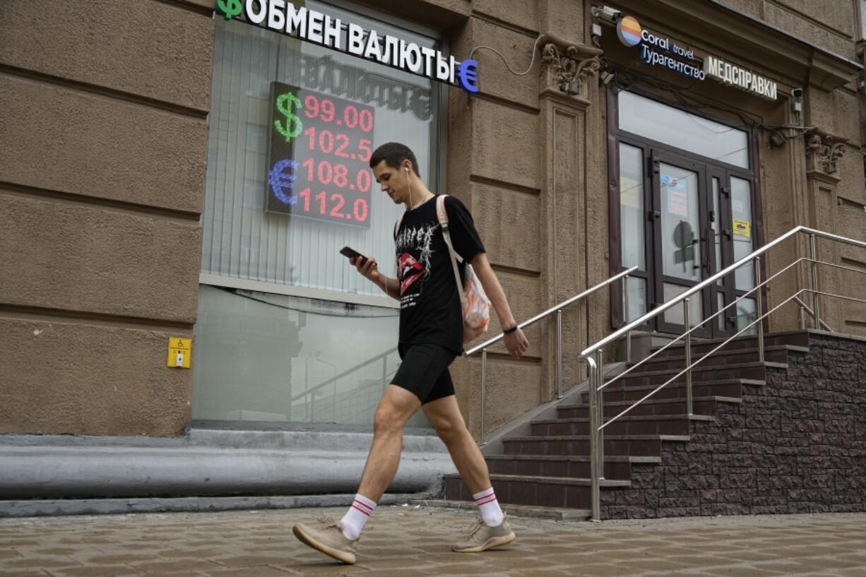 A man walks past a currency exchange office in Moscow, Russia, Monday, Aug. 14, 2023. Russia's central bank made a big interest rate hike of 3.5 percentage points on Tuesday, Aug. 15, 2023, an emergency move designed to fight inflation and strengthen the ruble after the country's currency reached its lowest value since early in the war with Ukraine.