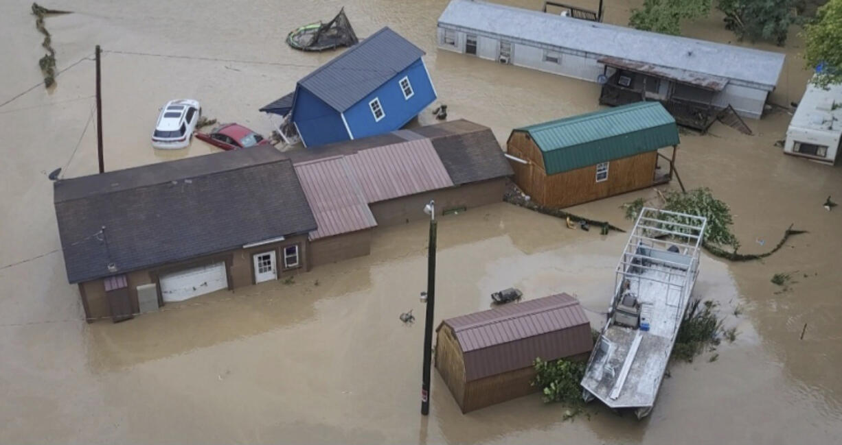 Vehicles and buildings are sit in floodwaters following heavy rains Monday, Aug. 28, 2023, in Chesapeake W.Va.