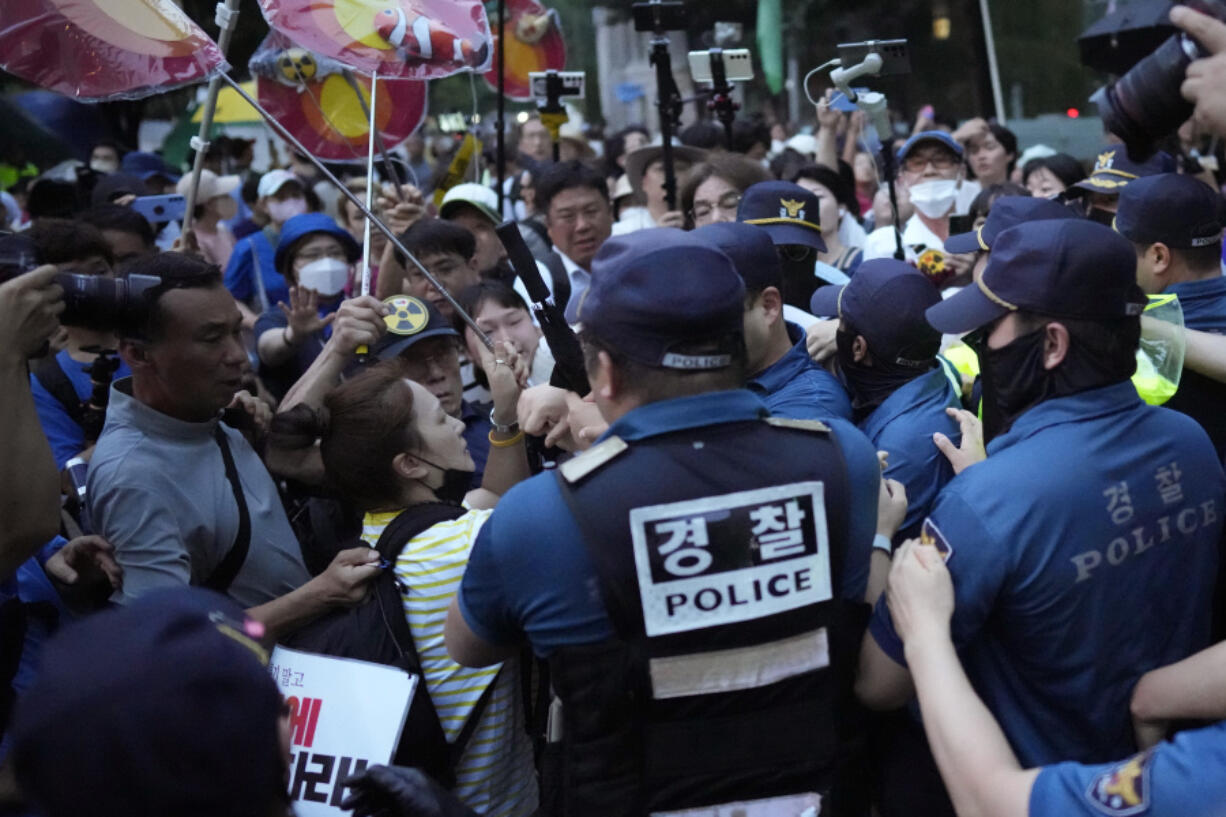 Protesters argue with police officers before a rally to demand the withdrawal of the Japanese government's decision to release treated radioactive water into the sea from the damaged Fukushima nuclear power plant, in Seoul, South Korea, Tuesday, Aug. 22, 2023. Japan will start releasing treated and diluted radioactive wastewater from the Fukushima Daiichi nuclear plant into the Pacific Ocean as early as Thursday -- a controversial step that the government says is essential for the decades of work needed to shut down the facility that had reactor meltdowns 12 years ago.