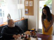 Lauren Kabakoff Vincent, right, interim executive director of Stonewall Gardens, talks with resident Billy Kurch at the LGBTQ+ assisted living facility, Tuesday, Aug. 15, 2023, in Palm Springs, Calif. The center's staff are required to go through sensitivity training to help make the center a more welcoming environment for residents, Vincent says. The training is key for making a more accepting environment for transgender residents and making them feel more at home.