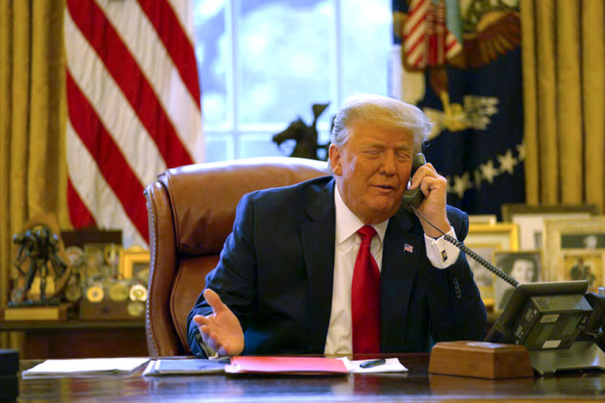 In this image released in the final report by the House select committee investigating the Jan. 6 attack on the U.S. Capitol, President Donald Trump talks on the phone to Vice President Mike Pence from the Oval Office of the White House on Jan. 6, 2021.