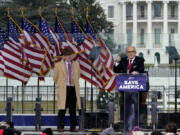 FILE - Chapman University law professor John Eastman stands at left as former New York Mayor Rudolph Giuliani speaks in Washington at a rally in support of President Donald Trump, called the "Save America Rally" on Jan. 6, 2021. The latest federal indictment against Donald Trump vividly illustrates the extent to which the former president's final weeks in office were consumed by a struggle over the law, with two determined groups of attorneys fighting it out as the future of American democracy hung in the balance.