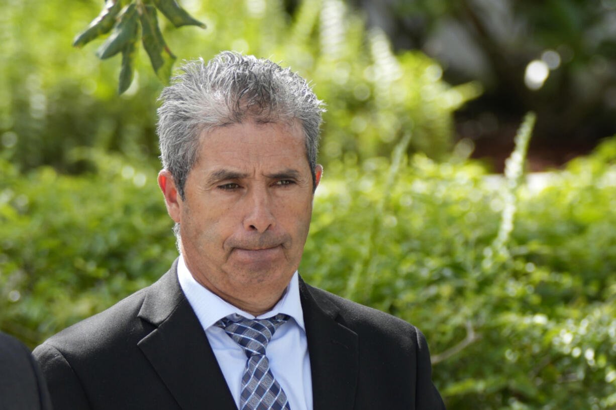 Carlos De Oliveira, center, property manager of former President Donald Trump's Mar-a-Lago estate, leaves the Alto Lee Adams Sr. U.S. Courthouse following his arraignment hearing, Tuesday, Aug. 15, 2023, in Fort Pierce, Fla.