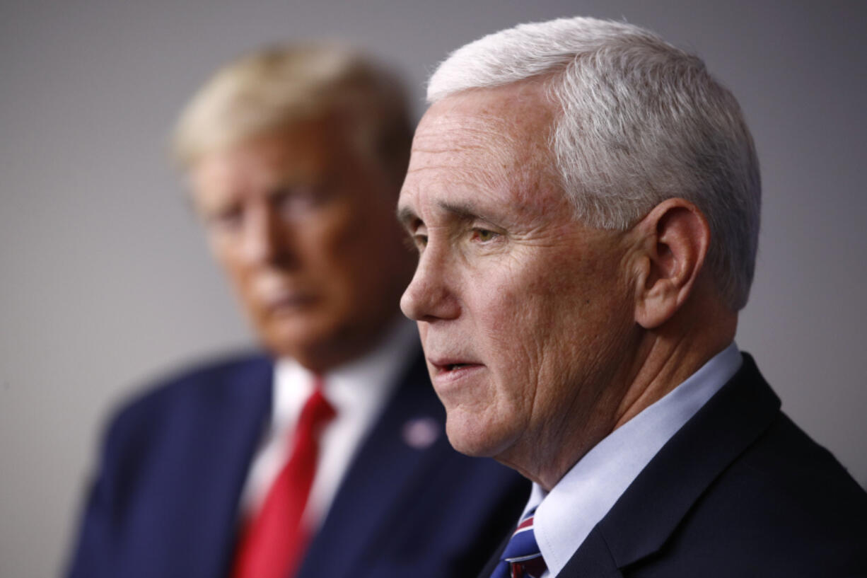 FILE - Vice President Mike Pence speaks alongside President Donald Trump during a coronavirus task force briefing at the White House in Washington on March 22, 2020. Former Vice President Mike Pence is refuting claims from ex-President Donald Trump's legal team that Trump never asked him to reject votes from certain states while certifying the 2020 election.