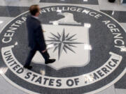 A man crosses the Central Intelligence Agency (CIA) seal in the lobby of CIA Headquarters in Langley, Virginia, on Aug. 14, 2008.