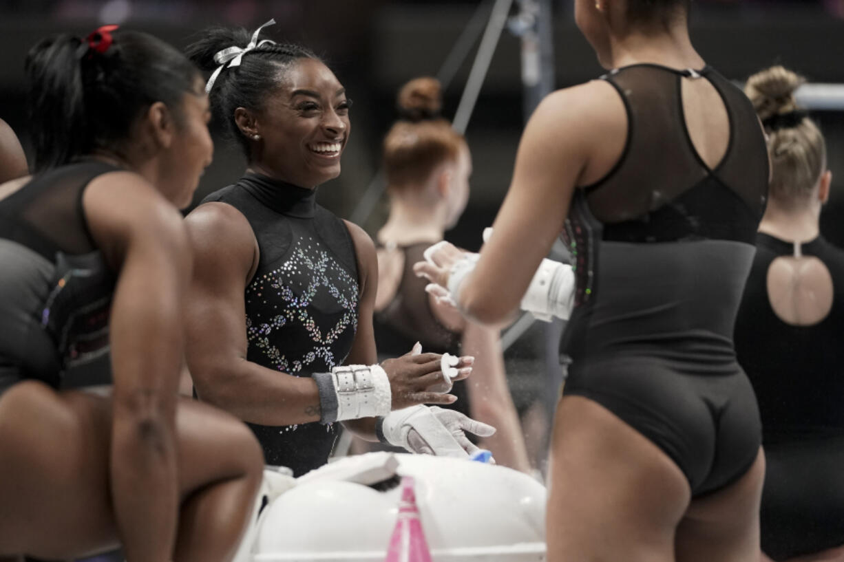 Simone Biles, center, warms up before the U.S. Gymnastics Championships Sunday, Aug. 27, 2023, in San Jose, Calif. (AP Photo/Godofredo A.