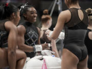 Simone Biles, center, warms up before the U.S. Gymnastics Championships Sunday, Aug. 27, 2023, in San Jose, Calif. (AP Photo/Godofredo A.