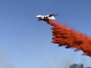 A Very Large Air Tanker drops fire retardant on the southwest flank of the Eagle Bluff Fire near the Canadian border on Aug. 5.