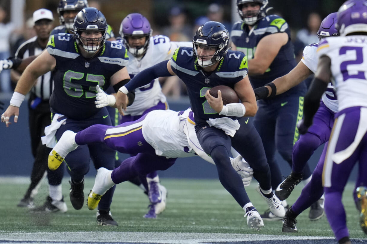 Seattle Seahawks quarterback Drew Lock (2) runs against the Minnesota Vikings during the first half of an NFL preseason football game in Seattle, Thursday, Aug. 10, 2023.