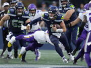 Seattle Seahawks quarterback Drew Lock (2) runs against the Minnesota Vikings during the first half of an NFL preseason football game in Seattle, Thursday, Aug. 10, 2023.