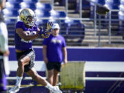 Washington running back Cameron Davis jumps to catch the ball during the NCAA college football team's practice Wednesday, Aug. 2, 2023, in Seattle.