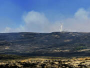 This photo provided by the White Creek Wind Project shows scorched ground from a wildfire seen in this photo taken at the White Creek Wind Project northwest of Roosevelt, Wash., on Saturday, July 22, 2023. Plant employees shut down the project's 89 turbines, as well as the 43 turbines at the nearby Harvest Wind project, as the Newell Road Fire raced through.