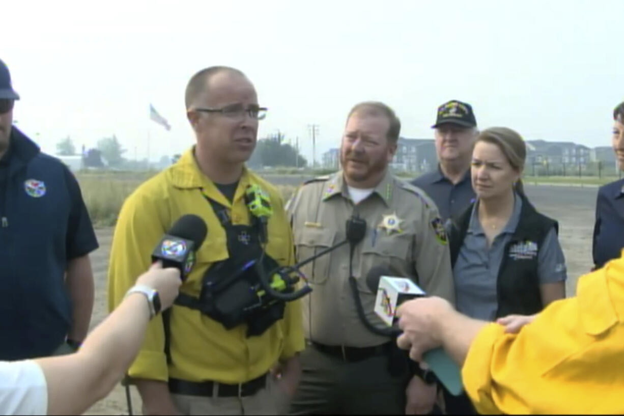 FILE - Spokane County Fire District 3 Chief Cody Rohrbach gives an update on the wildfires on Saturday, Aug. 19, 2023, in Medical Lake, Wash. Authorities say a second person has died in wildfires in eastern Washington state that sparked Friday, burning hundreds of structures and closing a section of a major interstate. Fire officials said Monday, Aug. 21, a body was found in the area of the Oregon fire north of Spokane on Sunday.