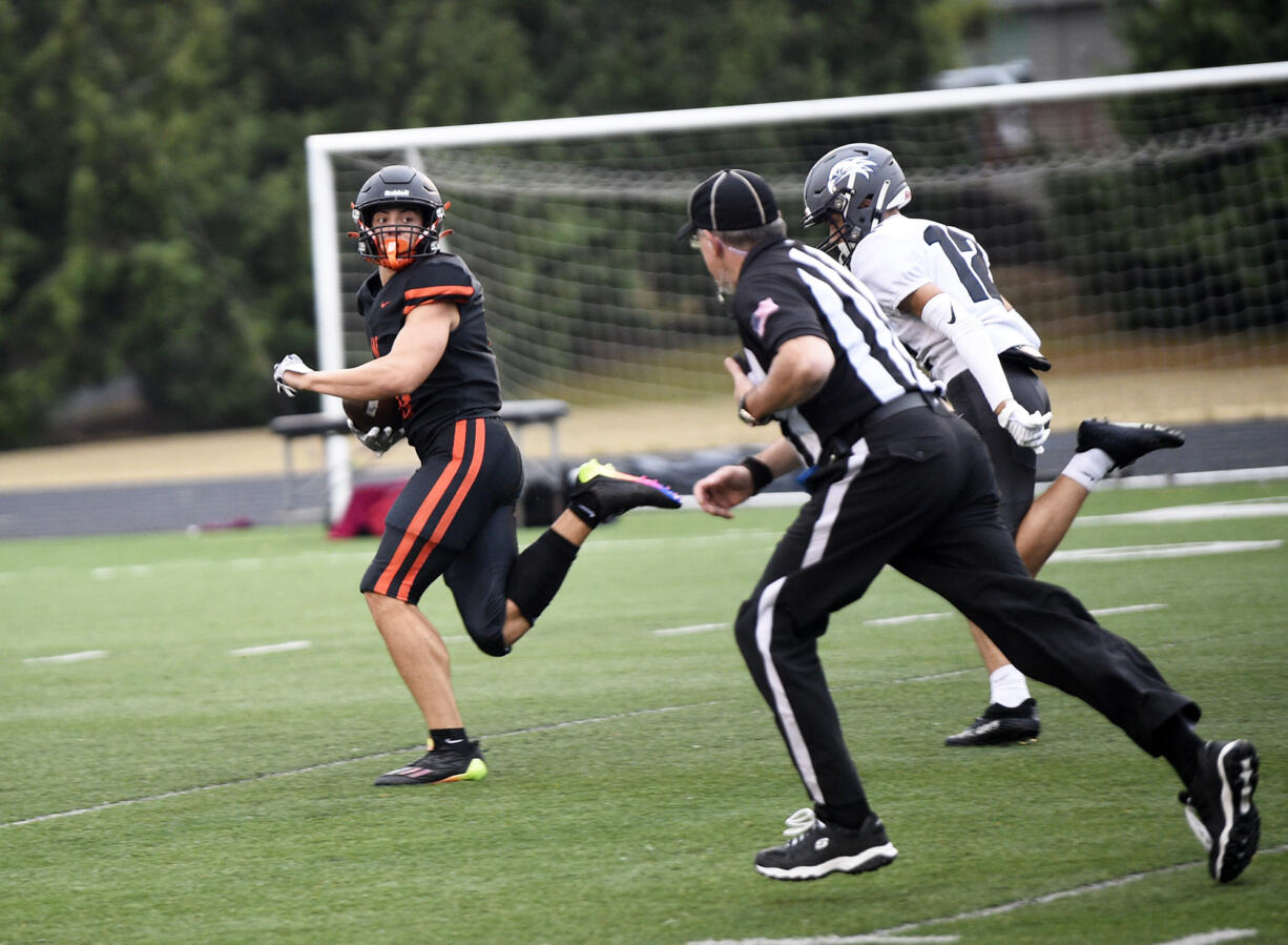 Washougal's Sam Evers (left) looks back at River Ridge's Kaden Haggard (12) during a game at Fishback Stadium in Washougal on Thursday, Aug. 31, 2023.