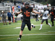 Washougal's Harry DeShazer celebrates his touchdown reception against River Ridge at Fishback Stadium in Washougal on Thursday, Aug. 31, 2023.