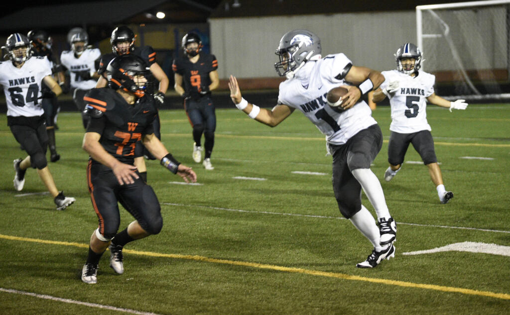 River Ridge's Darian Harper (1) tries to fend off Washougal's Ben Kellar (33) during a game at Fishback Stadium in Washougal on Thursday, Aug. 31, 2023.