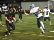 River Ridge's Darian Harper (1) tries to fend off Washougal's Ben Kellar (33) during a game at Fishback Stadium in Washougal on Thursday, Aug. 31, 2023.