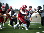 Fort Vancouver junior Denis Zayets runs ahead for extra yards against Vashon Island defenders on Saturday, Sept. 2, 2023, at Fort Vancouver High School.