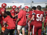 Fort Vancouver head coach Doug Bilodeau, center, talks to senior Ryan Faumuina (75) during a water break on Saturday, Sept. 2, 2023, at Fort Vancouver High School.