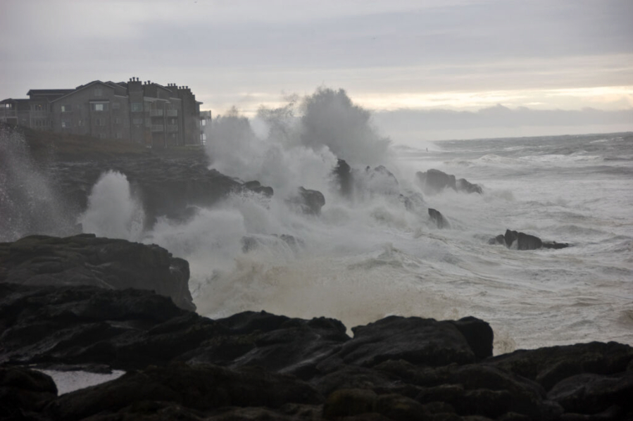 Waves pound a beach and structure between Depot Bay and Boiler Bay on the Oregon Coast.