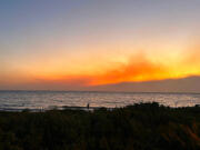 Smoke pools in the air from fires burning on Maui as the sun sets in Kihei, Hawaii, on Aug. 8, 2023. The fires are gone and tourism has yet to bounce back on the island.