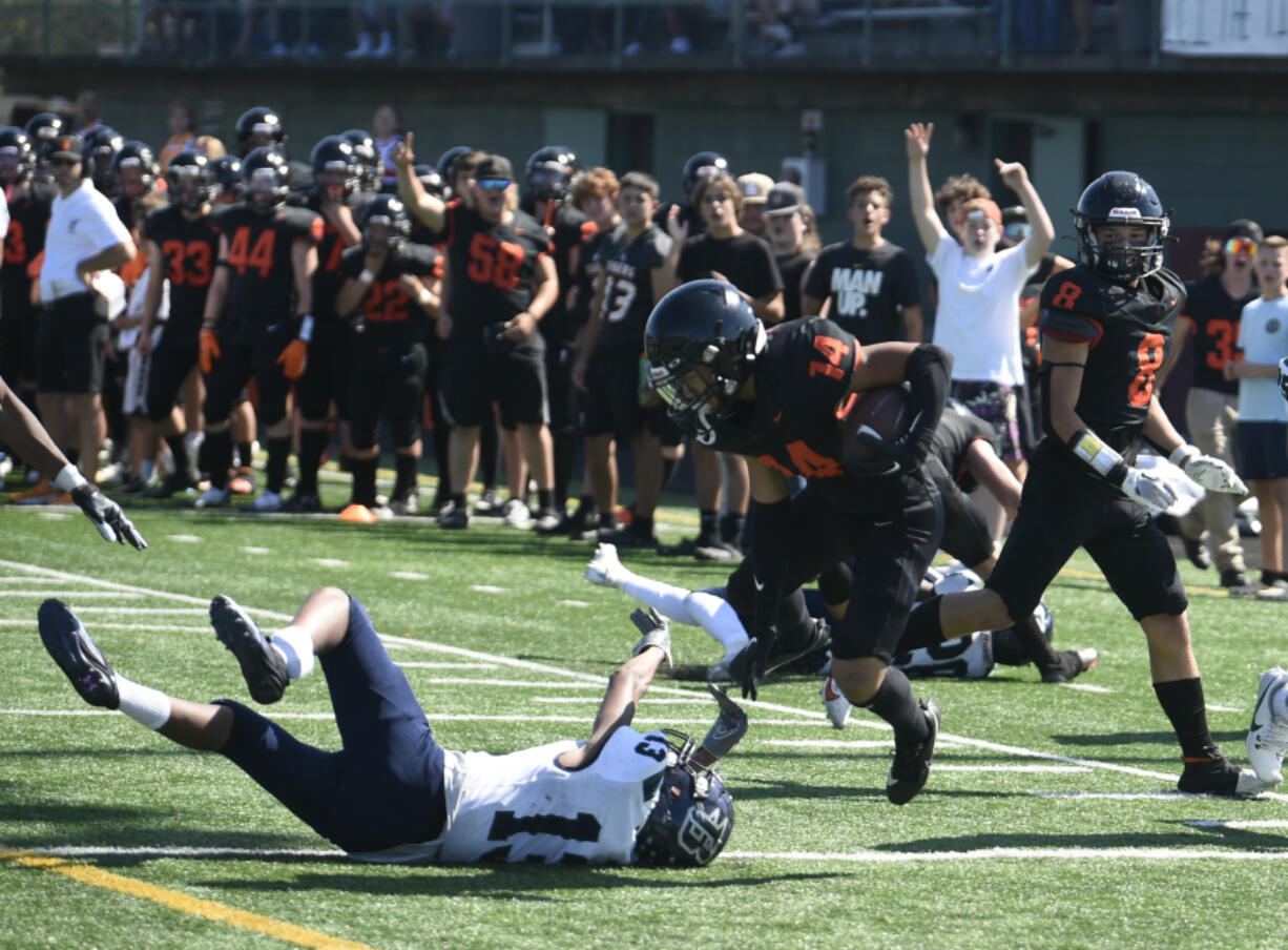 Battle Ground running back Dominick Rivas spins out of a Todd Beamer tackle before scoring a touchdown during a non-leauge football game Saturday, Spet. 9, 2023 at District Stadium in Battel Ground.