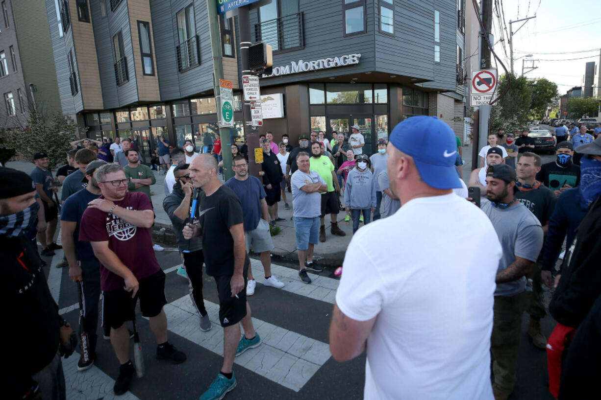 The presence of the armed white men outside a Fishtown police district alarmed neighbors, but cops allowed them to remain on the street after curfew.