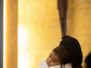 Maria Chirinos holds her son, Jhonder, 1, during mass before his baptism ceremony on Sunday, Sept. 10, 2023, at Corpus Christi Catholic Church in Miami. Many of the children baptized were migrant refugees being welcomed into the church as part of an outreach effort by the Hermanos de la Calle, a organization that combats homelessness.