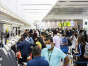 Passengers check in and wait by the Spirit Airlines ticket counter at Fort Lauderdale-Hollywood International Airport in Florida.