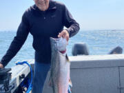 Richard Borneman of Vancouver is all smiles after landing this fall chinook recently at Buoy 10.