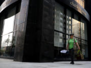 Annette Prince, director of Chicago Bird Collision Monitors, looks for dead and injured birds on May 11, 2022, in downtown Chicago. The volunteer group retrieves dead birds and helps get birds injured from collisions care at a nearby wildlife center.