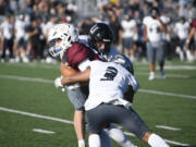 Union's Chase Lofton, center, and Yeshi Tsewang (3) combine to tackle Prairie receiver Jackson Kimball during Union's 27-13 win on Friday, Sept. 23, 2023 at District Stadium in Battle Ground.