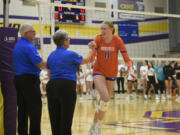 Ridgefield senior Lizzy Andrew greets officials before a volleyball match against Columbia River on Monday, Sept. 25, 2023 at Columbia River High School.