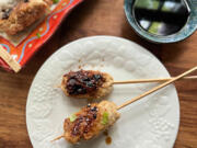 Chicken skewers with a salty-sweet yakitori sauce are simmered in water before being glazed on the grill.