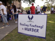 A sign equates fentanyl poisoning as murder during an Association of People Against Lethal Drugs rally outside the old Tarrant County Courthouse on May 6, 2023, in Fort Worth, Texas.