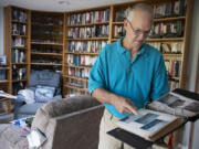 Author and former U.S. Marine Jeff Dacus looks over an album of photos from his service in the Persian Gulf War in 1991.