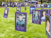 Photos of overdose victims fill a field during an Overdose Awareness Day event.