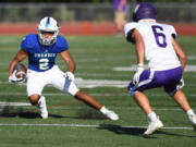 Mountain View senior Akili Kamau, left, cuts to avoid a defender Friday, Sept. 1, 2023, during the Thunder’s 35-21 loss to Nooksack Valley at McKenzie Stadium.