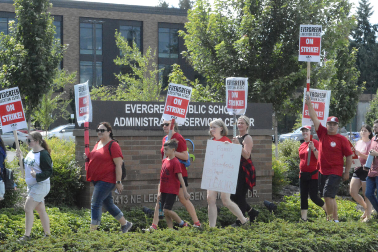 Evergreen Education Association members took a break from picketing outside their respective school locations to rally outside the Evergreen Public Schools district office Friday afternoon. Friday is the third day schools have been closed amid stalled contract negotiations with Evergreen teachers.