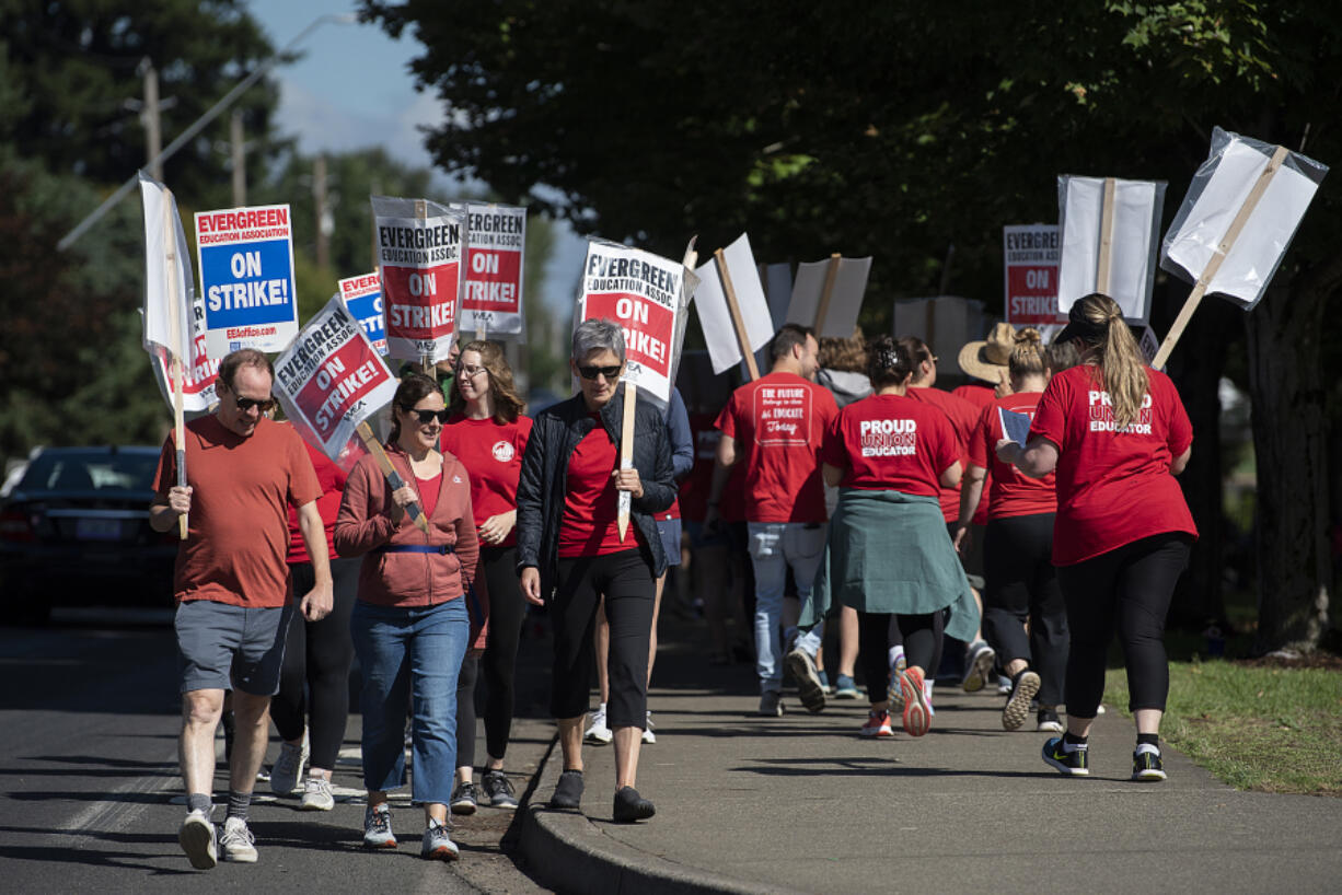 Striking educators keep in step as Evergreen Public Schools enters its fourth day on the picket line, as seen at Heritage High School on Monday morning. Union president Kristie Peak said Tuesday that two bargaining sessions held over the holiday weekend yielded no notable steps toward a deal on a new contract.