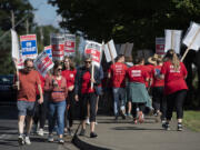 Striking educators keep in step as Evergreen Public Schools enters its fourth day on the picket line, as seen at Heritage High School on Monday morning. Union president Kristie Peak said Tuesday that two bargaining sessions held over the holiday weekend yielded no notable steps toward a deal on a new contract.