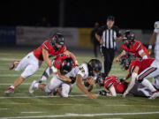 Lincoln's Jadeon Scranton (22) is tackled by Beau Harlan of Camas during the Papermakers' non-league football game against the Abes on Friday, Sept. 15, 2023, at Doc Harris Stadium.