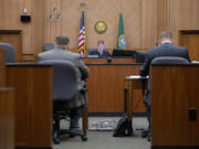 Judge John Fairgrieve listens as lawyers talk during the unlawful detainer docket at the Clark County Courthouse on a recent Thursday.